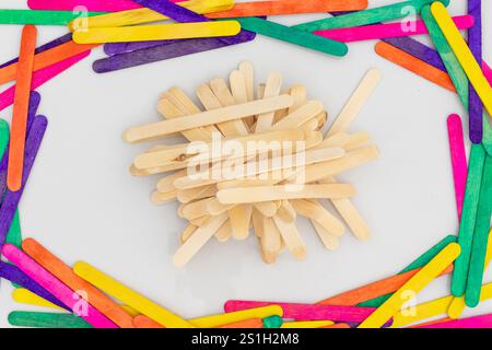 Popsicle wood sticks or Ice cream spatulas with wooden texture or medical examination sticks with a colorful sticks frame isolated on white background Stock Photo