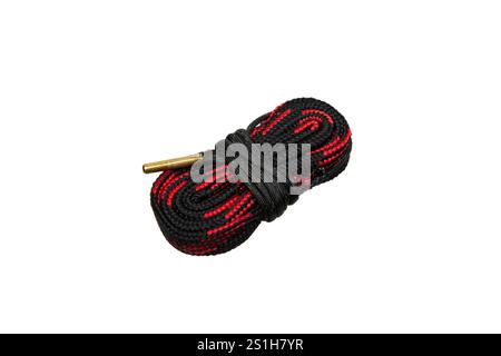 A black and red gun cleaning bore snake with a brass weight, coiled and ready for use, isolated on a white background, ideal for firearm maintenance a Stock Photo