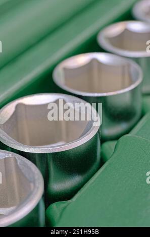 Set of shiny steel hexagonal sockets for wrench in a plastic toolbox. Close up shot, abstract technology background. Stock Photo