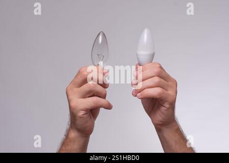 light bulbs in the hands on a white background. Stock Photo