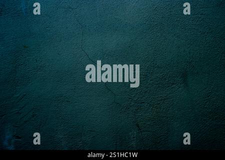 Textured dark teal wall features subtle visual cracks, evoking artistic and architectural elements. Ideal for backgrounds, design, or themes of imperf Stock Photo