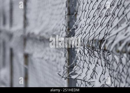 Metal link fence with wire Stock Photo