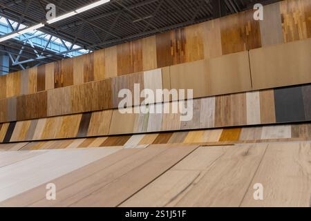 Variety of wooden flooring with different textures and colors in construction supermarket. This image capture an expansive display of floor samples, h Stock Photo