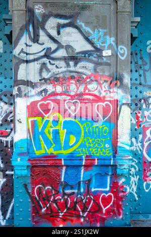 a vibrant and heavily graffitied cast iron plaque on manhattan bridge new york usa Stock Photo