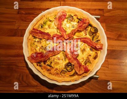 Quiche lorraine-French pie with bacon leek and mushrooms, top view. Stock Photo