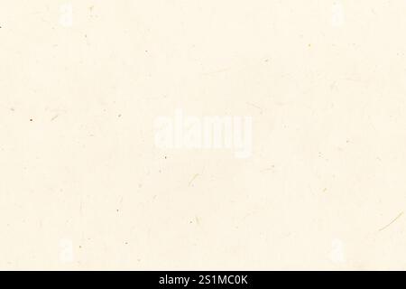 Handmade paper with visible natural fibers. Meant as pastel colored yellow background. Stock Photo