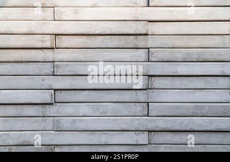 Front view of a wall made of gray concrete slates. Abstract high resolution full frame textured background, copy space. Stock Photo