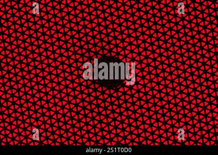 RGB Light Speaker Protective Cover Texture on Red Background Stock Photo