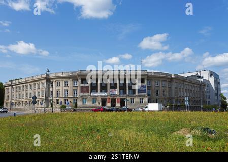 Large classical building with columns, surrounded by green lawns under a blue sky, Faculty of Philology of the University, BiaNystok, Bialystock, Bje Stock Photo
