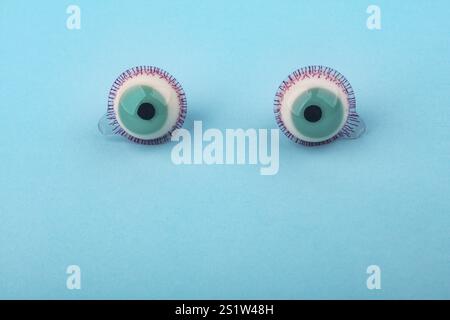 Decorative fruit candy eyes over light blue background. Conceptual photo using for funny celebration themes Stock Photo
