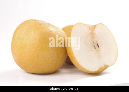 Two Asian pears on a white background, one whole and one sliced, showcasing their fresh texture Stock Photo