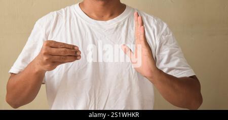 Young man deaf mute man showing number 500 using sign language Stock Photo