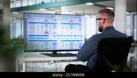 Calculating Electronic Medical Accounts And Codes In A Black Office Using A Spreadsheet On A Computer Screen. Stock Photo