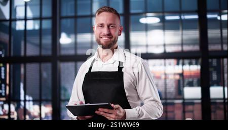 Restaurant Owner And Manager In Front Of His Shop Stock Photo