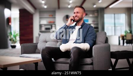 Injured Man After Accident With Broken Arm On Couch Stock Photo