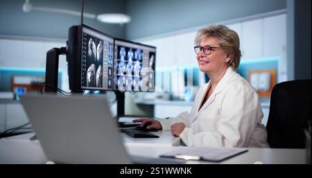 Radiologist Dentist Using X Ray Software On Desktop Computer Stock Photo