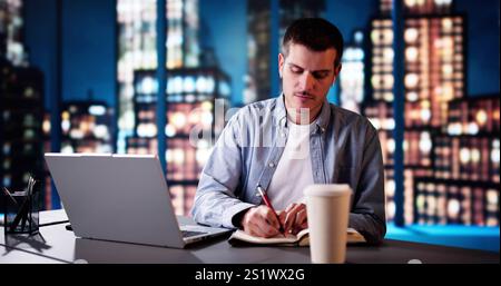 Man Studying And Working On Laptop With Wireless Headphones Stock Photo