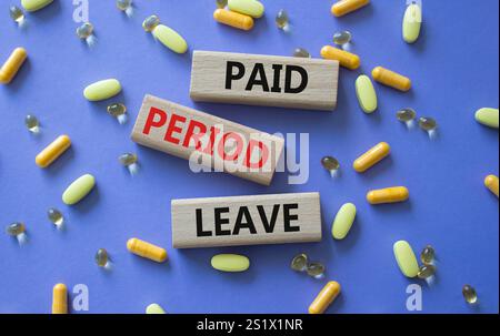 Paid Period Leave symbol. Concept words Paid Period Leave on wooden blocks. Beautiful purple background with pills. Healthcare and Paid Period Leave c Stock Photo