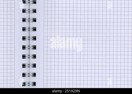 Detail of an open spiral block with white checkered paper Stock Photo