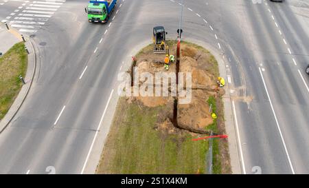 Aerial view of road construction with workers and machinery on a median. Stock Photo