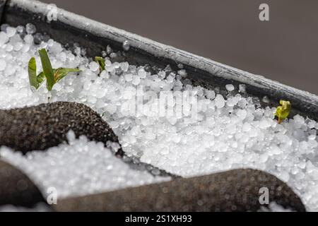 Close-up of hailstones in the gutter of an apartment building Stock Photo