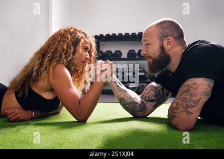 sportswoman during arm wrestling with bodybuilder Stock Photo