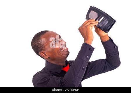 portrait of a handsome young man upset holding an empty wallet. Stock Photo