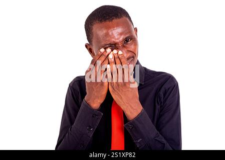 portrait of a handsome young man standing and touching his eye. Stock Photo