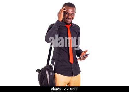 handsome young businessman carrying a bag on his shoulder and a mobile phone going to work. Stock Photo