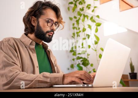 Cheerful young man working at his home Stock Photo
