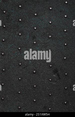 Grunge steel industrial boat floor plate painted dark gray black anti-rust paint. Robust ferry ship metal pattern. Old dotted iron deck. Worn metal te Stock Photo