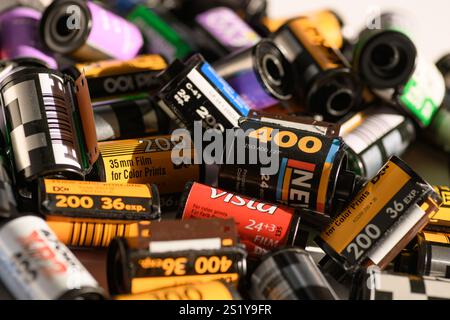 Izmir, Turkey - Jan 05 2025: A detailed close-up of various 35mm negative film cartridges, including Kodak, Fujicolor, and others, piled together on a Stock Photo