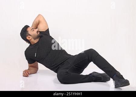 portrait of an asian stylish male model in black tshirt and black jeans against white background Stock Photo