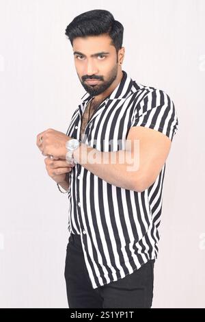 Portrait of an indian young male model in stripe shirt resemble in vicky kaushal Stock Photo