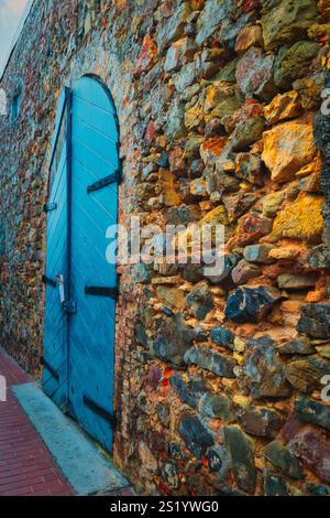 This bold blue door set against a rustic stone wall exudes history and character. A reminder of timeless beauty and cultural authenticity, it invites Stock Photo