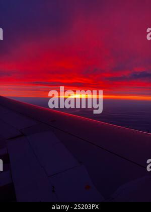 Beautiful, orange, red purple sunset from airplane window Stock Photo