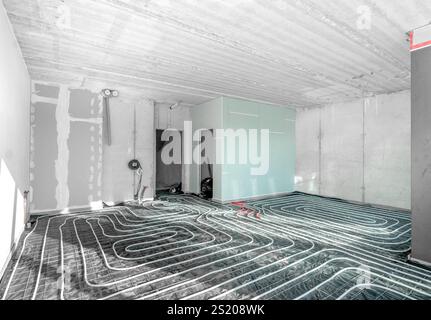 Water underfloor heating. Floor heating system installation heating system in construction of new built residential home. Pipes and pipelines. Interio Stock Photo