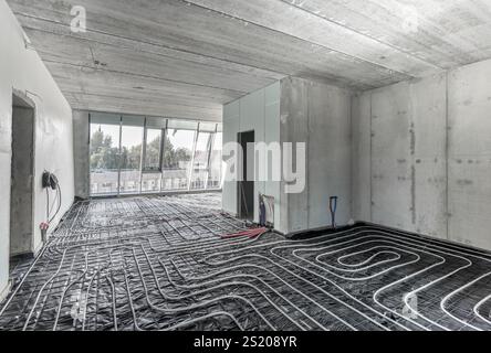 Water underfloor heating. Floor heating system installation heating system in construction of new built residential home. Pipes and pipelines. Interio Stock Photo
