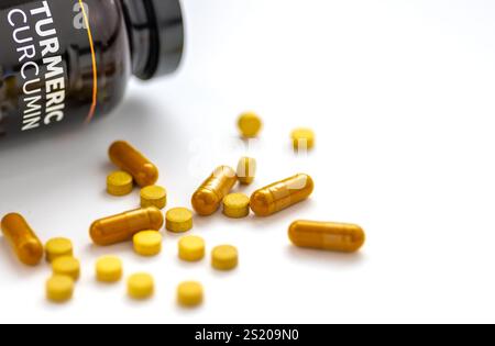 Turmeric curcumin tablets health supplements isolated on white. Stock Photo