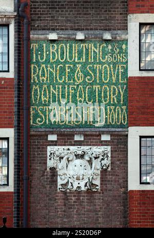 Mosaic lettering advertising the firm of T. J. Boulting & Sons, on the side of a building in Riding House Street, London. Stock Photo