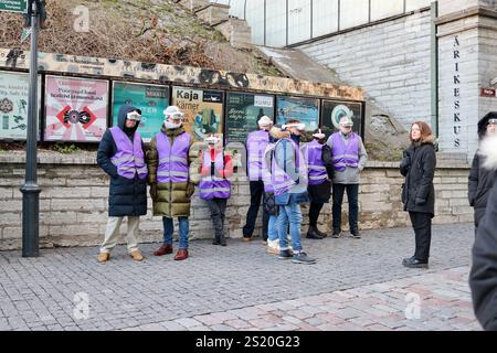 Tourists in Tallinn, Estonia, exploring the historic city with AI headsets, blending modern travel technology with timeless charm in an immersive tour Stock Photo