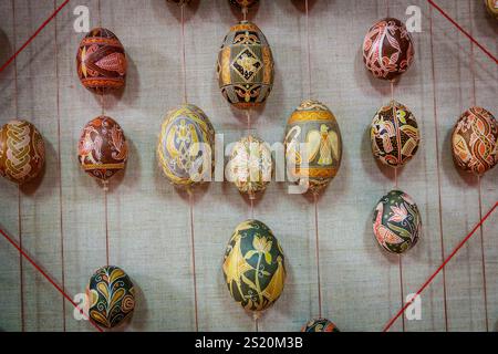 A wall of colorful eggs with a patterned design. The eggs are arranged in a diamond shape Stock Photo