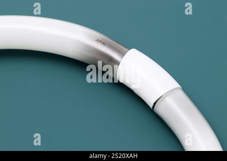 Black burn on the circular fluorescent light, Electronic waste on table background Stock Photo