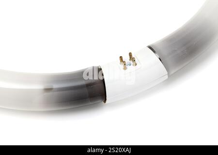 Black burn on the circular fluorescent light, Electronic waste on a white background Stock Photo
