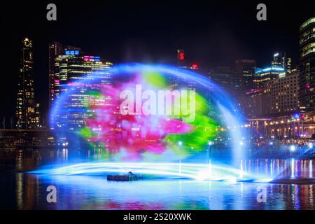 "Vivid Sydney" lighting festival, Sydney, Australia. Images of flowers projected onto a jet of water in Darling Harbour Stock Photo