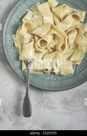 Pasta papardelle in creamy garlic sauce, traditional Italian cuisine, pasta carbonara, homemade, no people Stock Photo