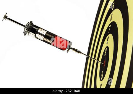 A doctor's syringe in the centre of a target. Injection with blood. Austria Stock Photo