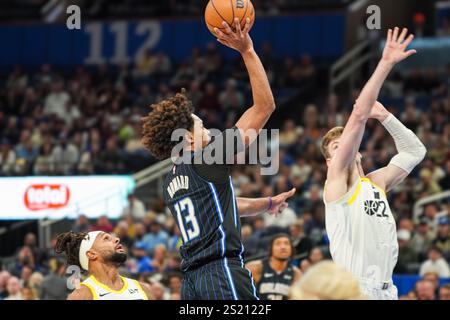 Orlando Magic guard Jett Howard, middle, is helped up by his bench ...