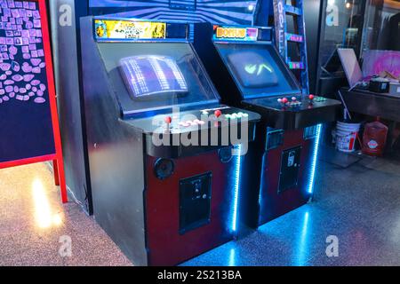 Arcade games in Buenos Aires' Bond Street gallery with predominantly dark slum-style neon lights Stock Photo