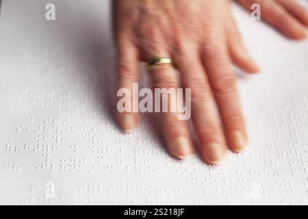 Fingers and Braille. Blind people read a book in Braille, Fingers and Braille. Blind people read a book in Braille. Austria Stock Photo